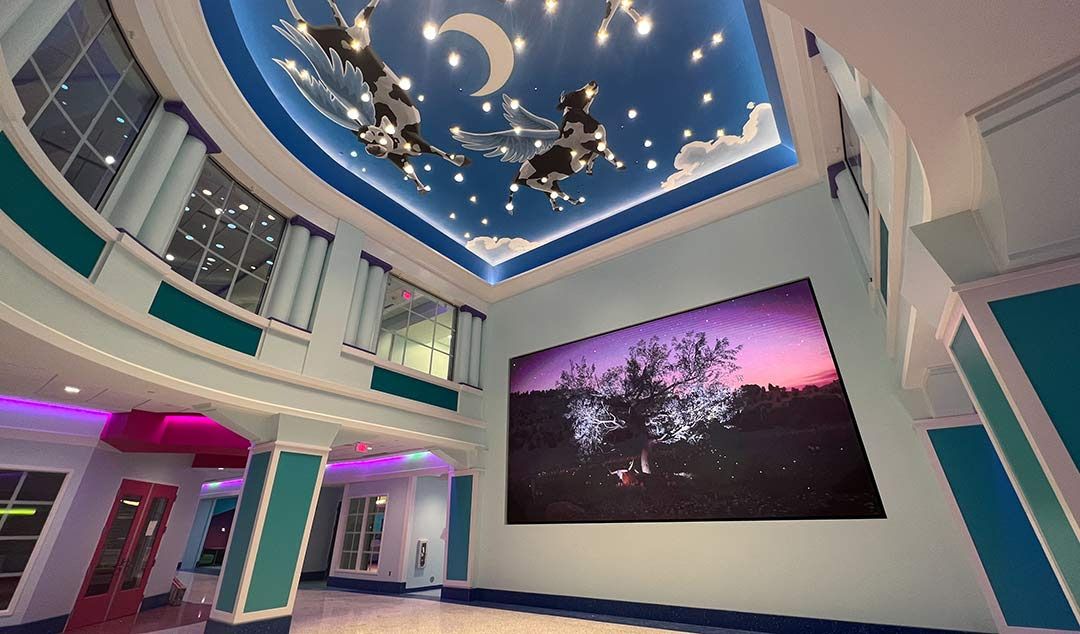 A beautiful room in Cook&#039;s Children&#039;s Hospital, with the ceilings a blue sky and clouds and massive Daktronics video displays adding to the experience. 