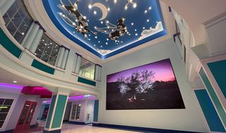 A beautiful room in Cook's Children's Hospital, with the ceilings a blue sky and clouds and massive Daktronics video displays adding to the experience. 