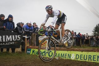 Image shows a rider bunny hopping on a cyclocross bike