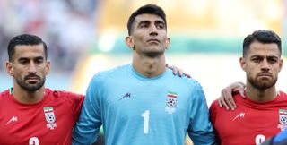 Iran players stand in silence for the national anthem ahead of their 2022 World Cup group match against England in Qatar, protesting against their country's government