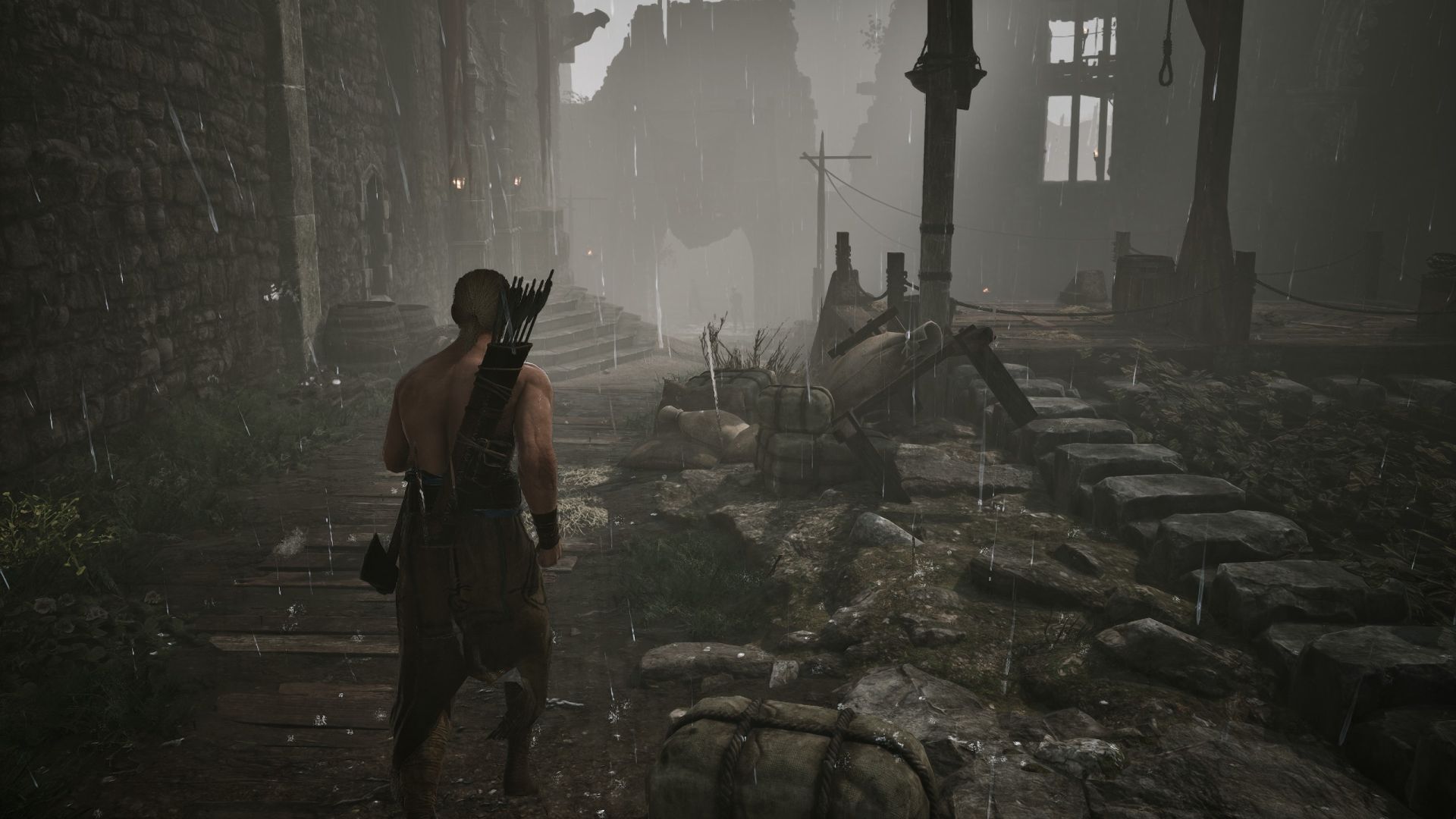 A shirtless man jogs through the Old Camp in the rain