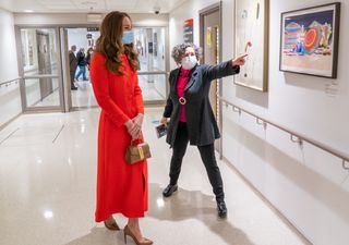 Catherine, Duchess of Cambridge is shown the artwork on display by Director of Vital Arts for Barts Health NHS Trust, Catsou Roberts, during a visit to the Royal London Hospital Whitechapel on May 7, 2021 in London, England