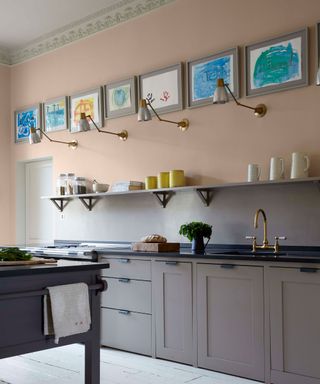Open shelving storing pots and jugs above neutral cabinets with a dark worktop