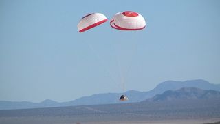 Boeing's CST-100 space capsule falls to Earth in a successful parachute drop test held April 3, 2012, at the Delamar Dry Lake Bed near Alamo, Nev.