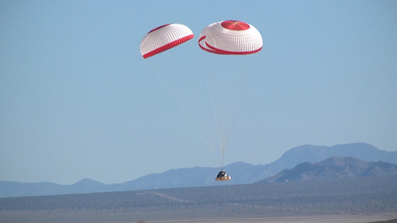Boeing's CST-100 space capsule falls to Earth in a successful parachute drop test held April 3, 2012, at the Delamar Dry Lake Bed near Alamo, Nev.