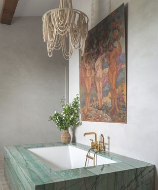 grey walled bathroom with artwork above wall and quartz rectangular inbuilt tub surround