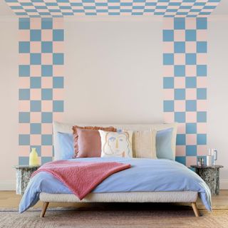 Bedroom with checkerboard walls and bed with blue bedding