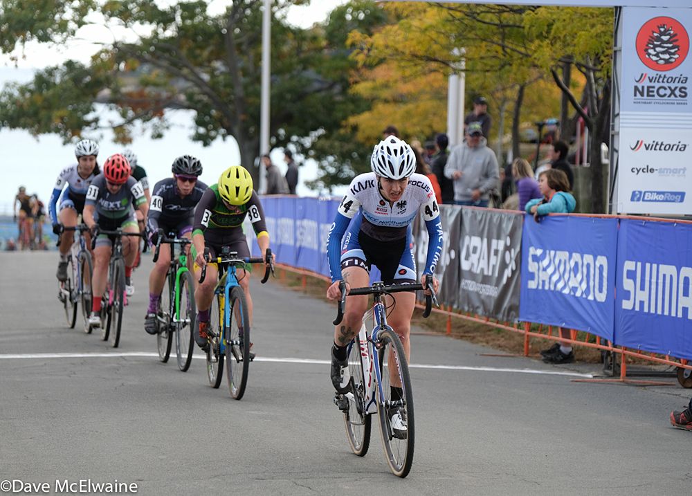 Rhys May (JAM-NCC) leading a chase group through the start area with one lap remaining