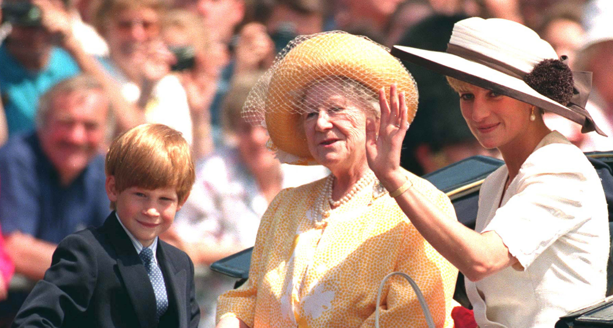 Princess Diana, Prince Harry and the Queen Mother riding in a carriage
