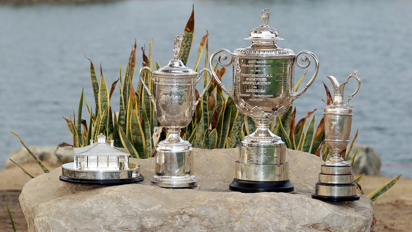 All four Major golf trophies on a rock