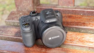 Kodak PixPro AZ405 digital camera in black on a wooden slatted table