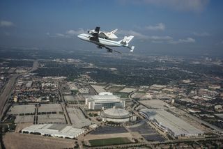 Space Shuttle Endeavour is ferried by NASA's Shuttle Carrier Aircraft (SCA) over Houston, Texas on September 19, 2012. NASA pilots Jeff Moultrie and Bill Rieke are at the controls of the Shuttle Carrier Aircraft. Photo taken by NASA photographer Sheri Locke in the backseat of a NASA T-38 chase plane with NASA pilot Thomas E. Parent at the controls.