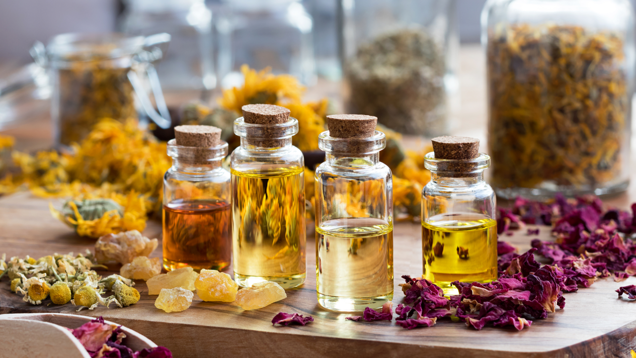 dried roses and bottles on a table