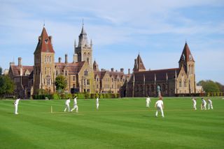 Boys playing cricket in the grounds of Charterhouse School