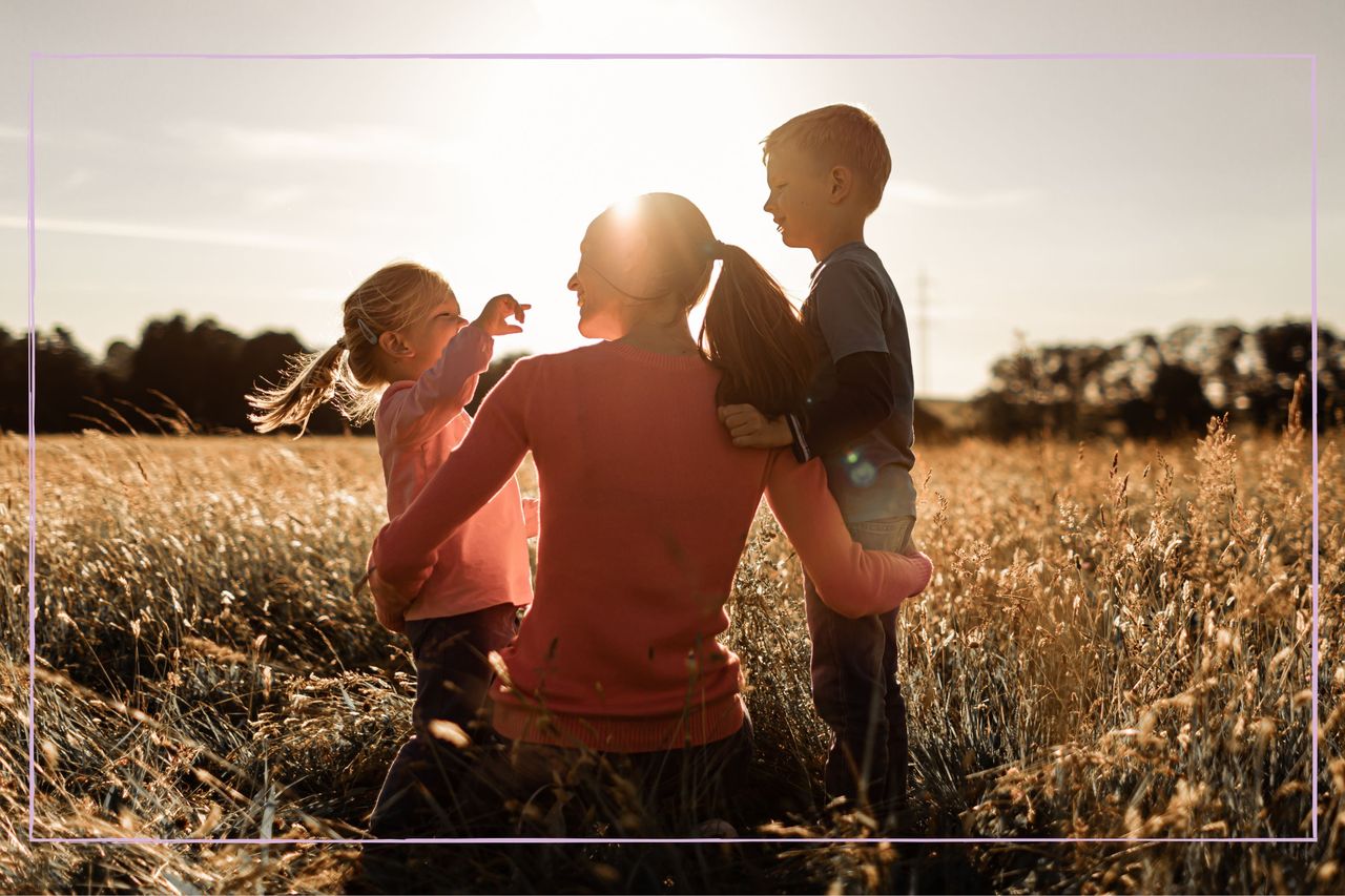 Mother with her two children watching the sunset