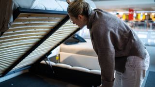 A woman using an ottoman bed