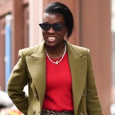 Nikki Ogunnaike wearing a red shirt, a green blazer, and leopard pants