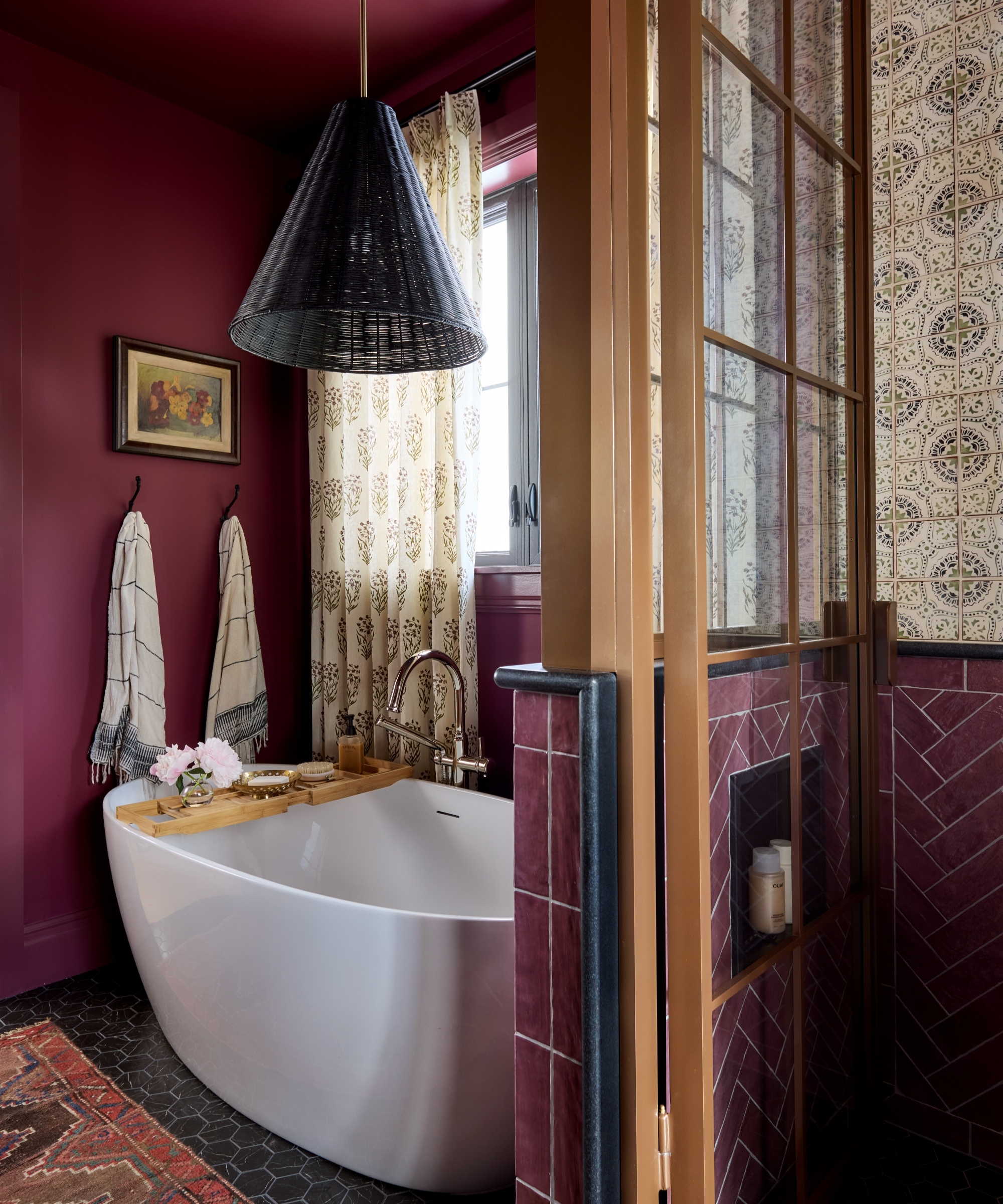 A luxury bathroom color drenched in deep purple paint and tiles