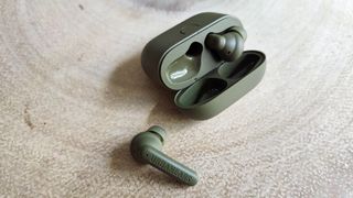 Urbanears Boo review: true wireless earbud on a table next to the case