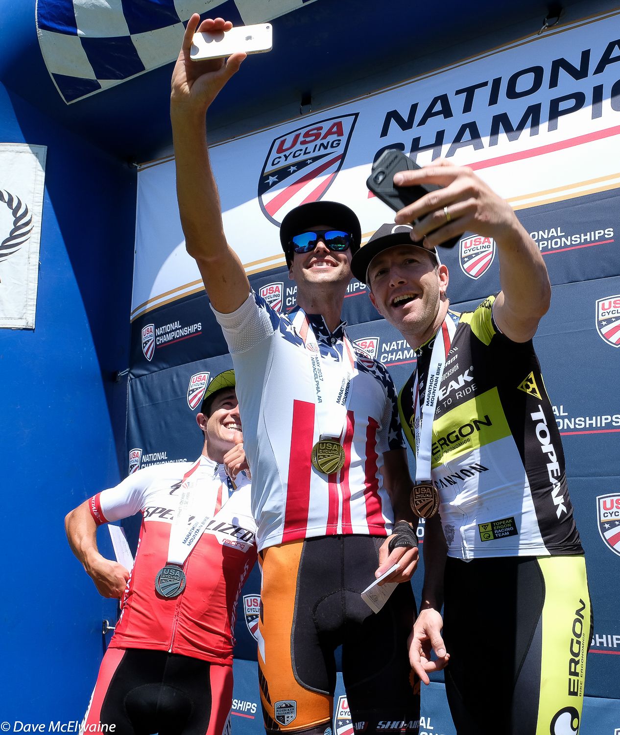 Payson McElveen (Orange Seal-Ridebiker) and Jeremiah Bishop amuse themselves by taking selfies as Howard Grotts looks on.