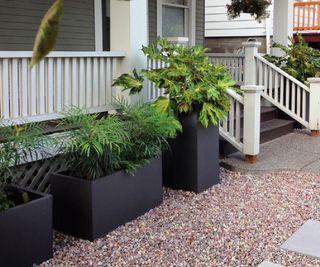 Large square planters at the front of a porch