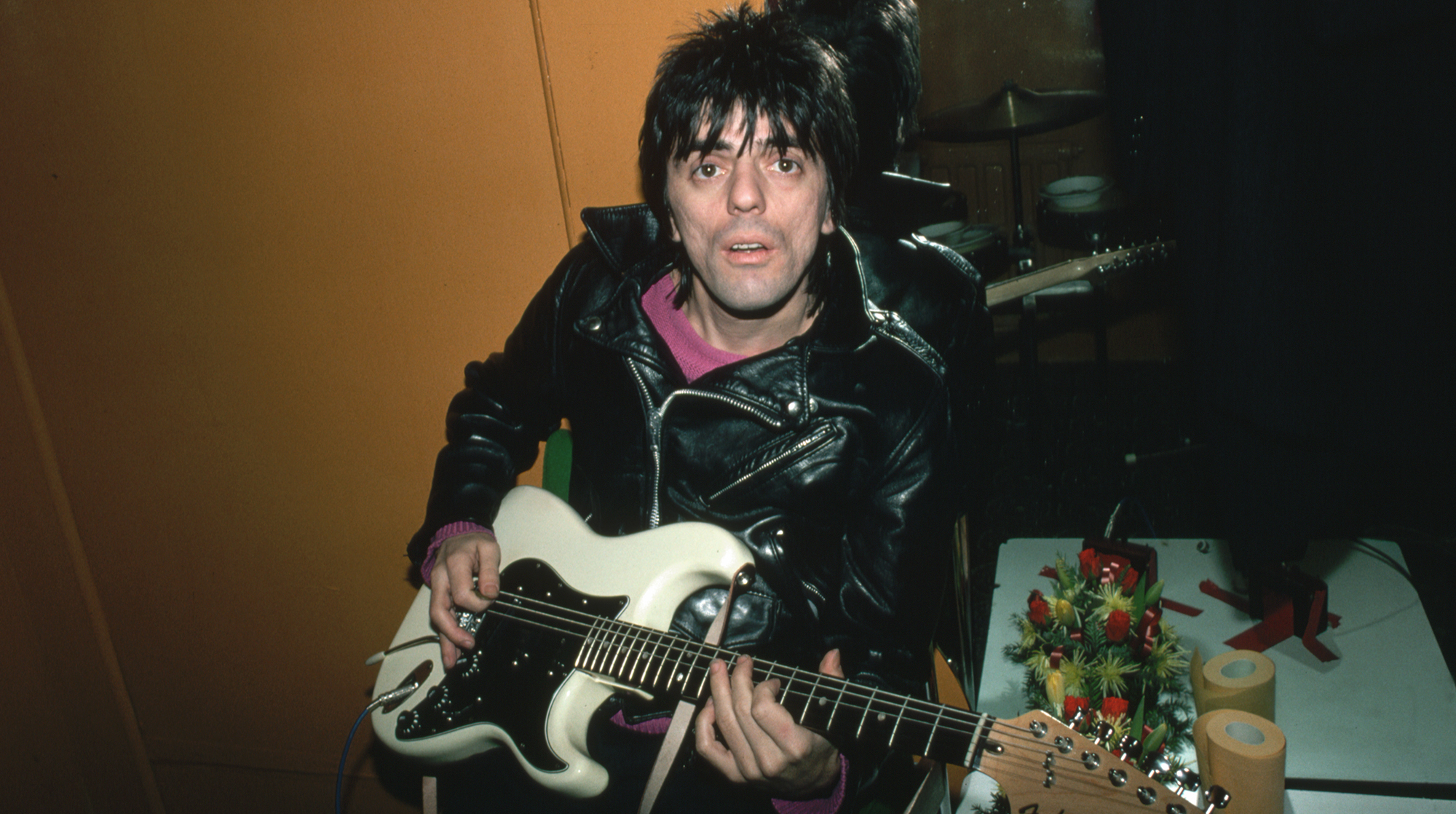 (Original Caption) : 1980-Photo shows Frank Infante, bassist-turned guitarist with the New Wave rock and roll group Blondie, seated and playing guitar, 1980