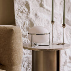 Very chrome lamp on wood sidetable.