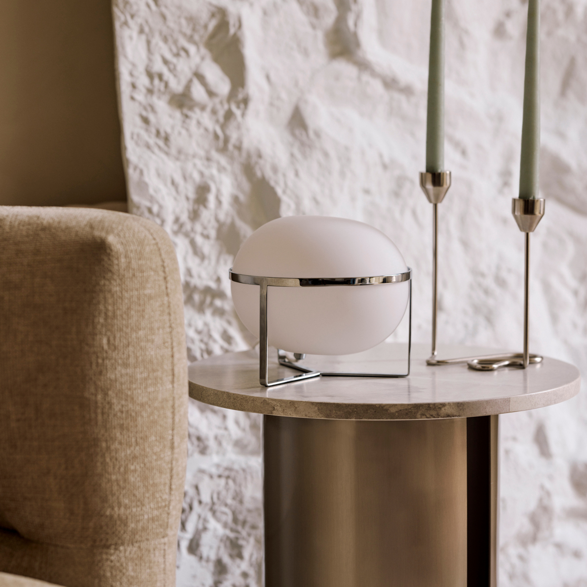 Very chrome lamp on wood sidetable.