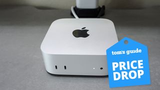 A Mac mini M4 on a desk with a Tom's Guide Price Drop deal badge