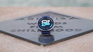 The Samsung Galaxy Watch 8 showing an athletic watch face on a plaque.