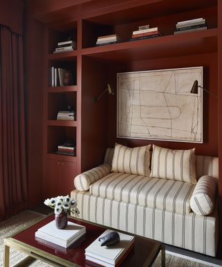 Rust living room with striped patterned sofa by Wendy Labrum