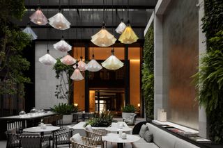capella sydney hotel interior with seating and triple height ceilings