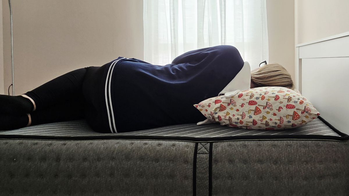 Mattress tester side sleeping on the Siena Premier Hybrid Mattress in her bedroom