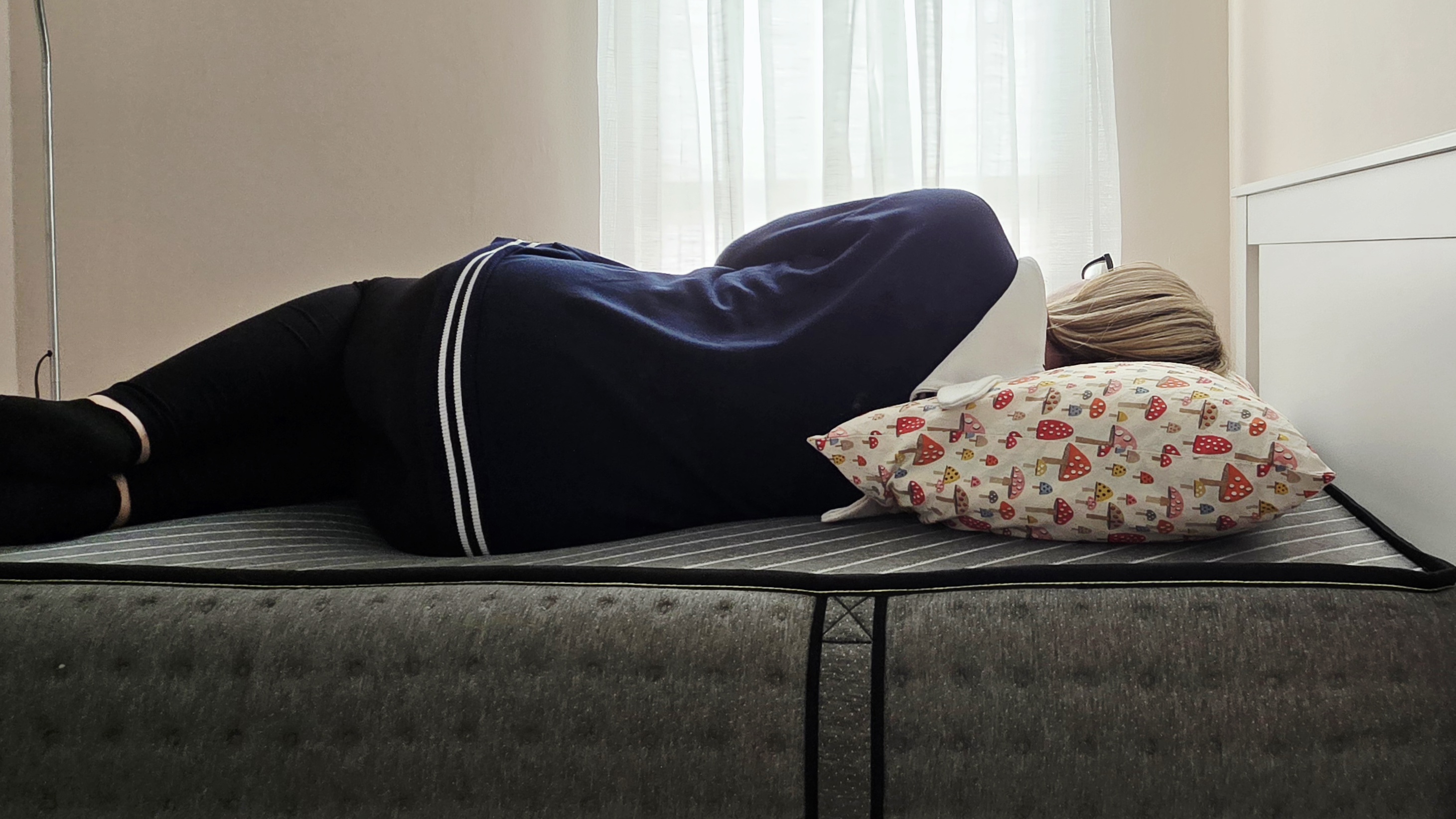 Mattress tester side sleeping on the Siena Premier Hybrid Mattress in her bedroom