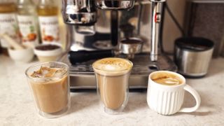 3 finished AI-generated coffee recipes in front of an espresso machine