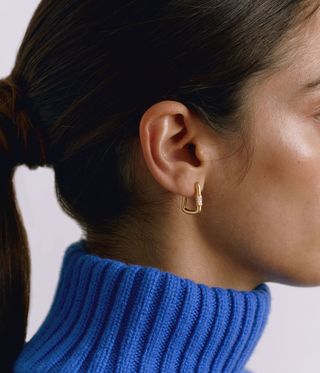 woman wearing gold earring by Alex Eagle x Kimaï