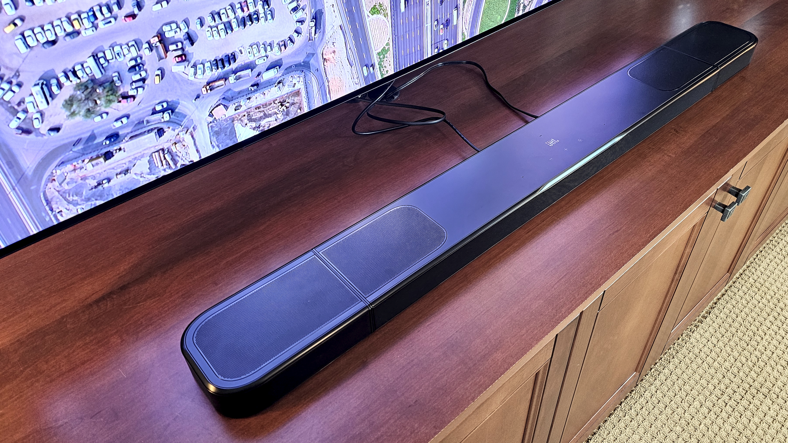 JBL Bar 1000MK2 on TV stand showing up-firing Atmos speakers