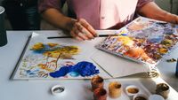 An artist uses some of the best acrylic paints on an easel