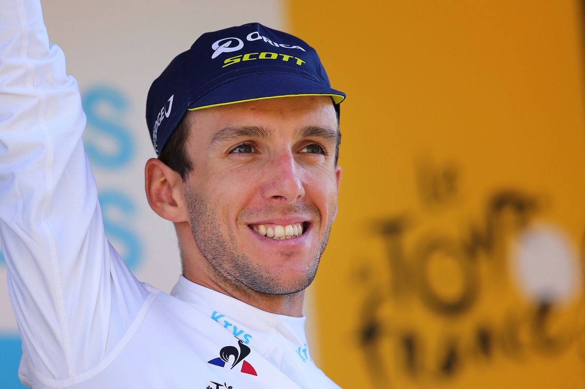 A very happy Simon Yates (Orica-Scott) on the podium to collect the white jersey