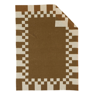 A brown and cream checked throw blanket