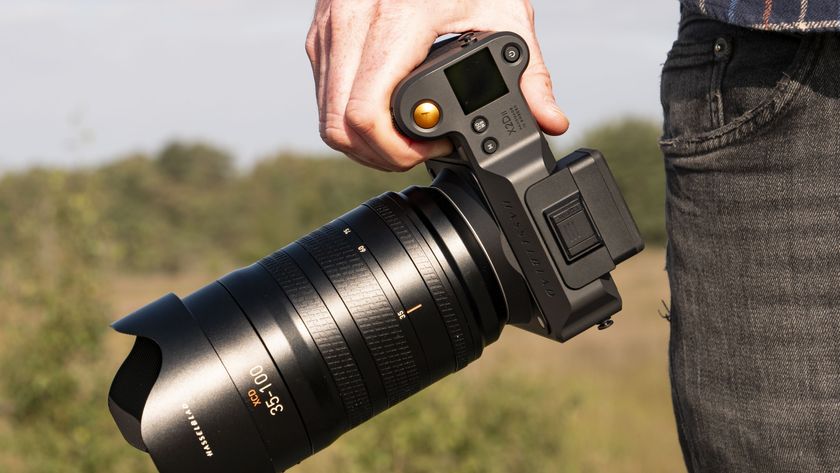 Hasselblad X2D II 100C camera in the hand, outdoors at first light