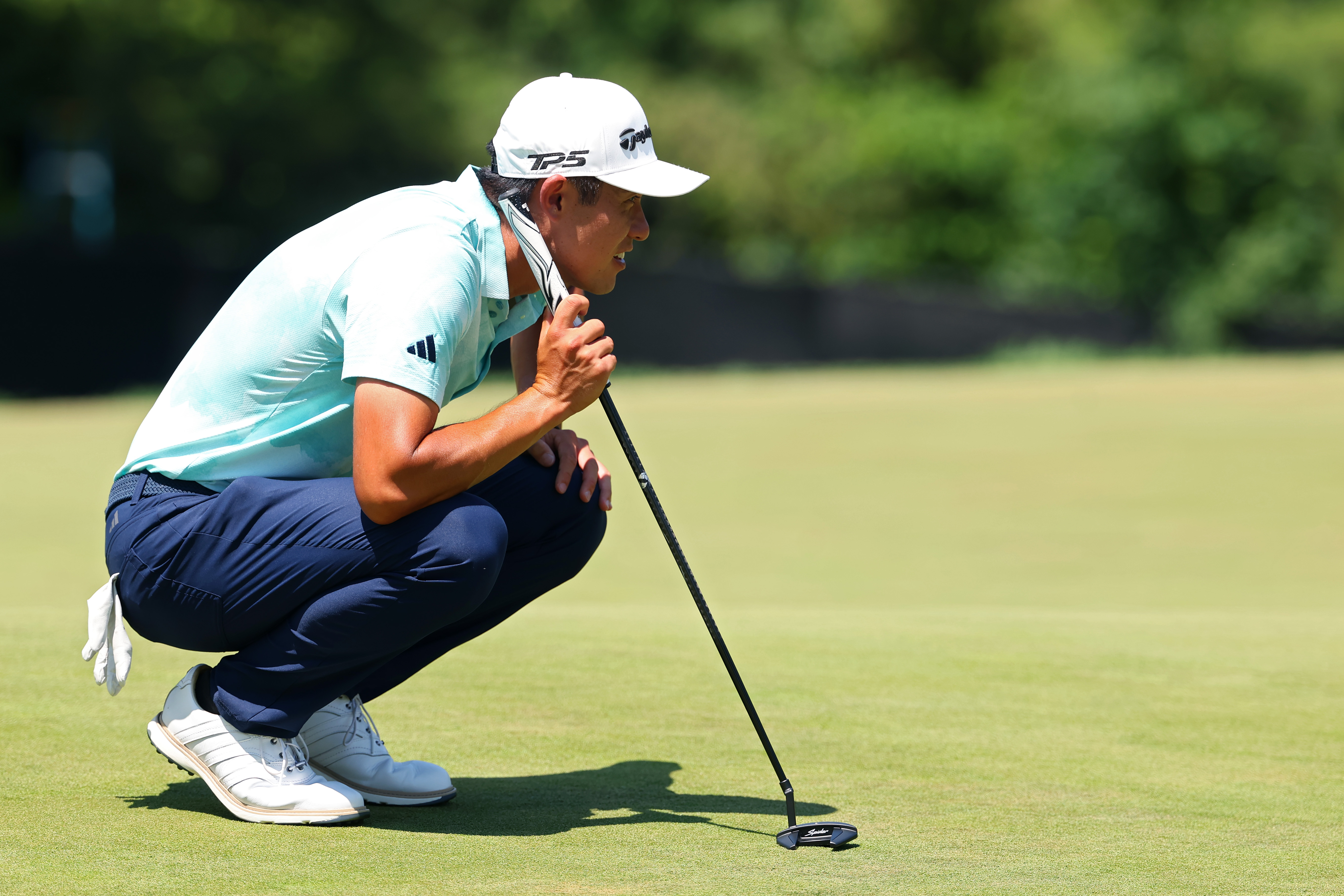 Collin Morikawa lines up a putt