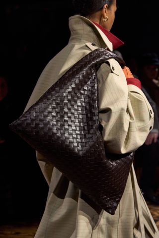 Bottega Veneta model carrying a slouchy handbag on the runway