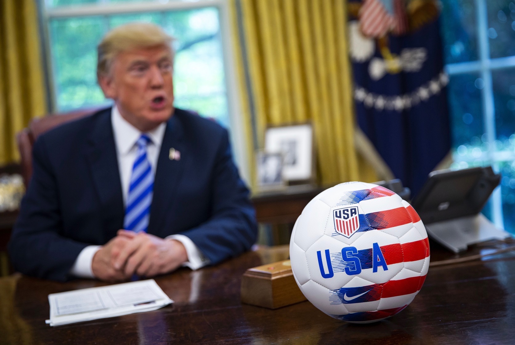 A USA soccer ball is placed on the Resolute Desk as U.S. President Donald Trump speaks during a meeting with Gianni Infantino, president of FIFA, not pictured, in the Oval Office of the White House in Washington, D.C., U.S., on Tuesday, Aug. 28, 2018. The 2026 FIFA World Cup will be held in the United States, Canada, and Mexico. 