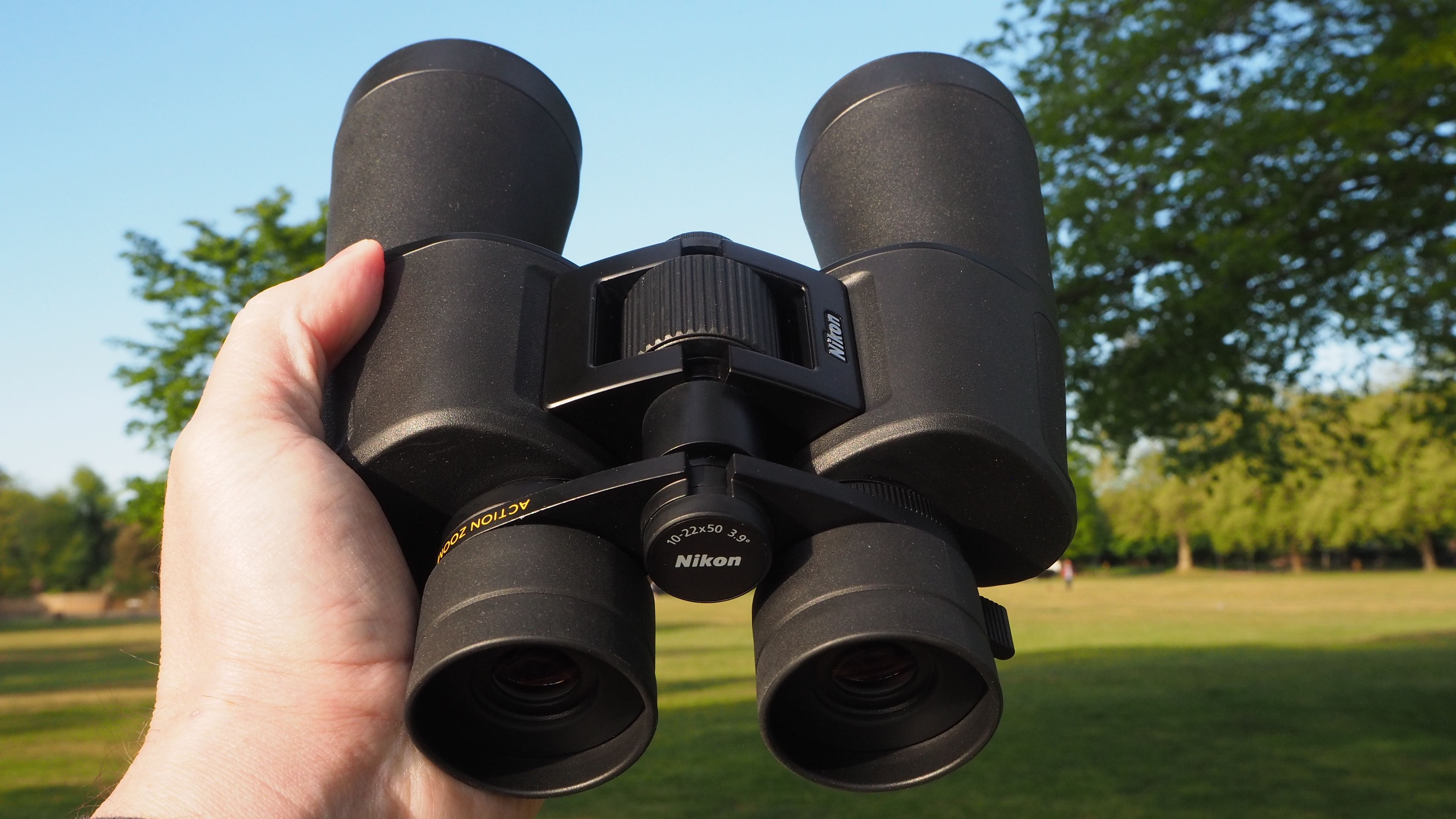 Nikon Action Zoom 10-22x50 binoculars in a person's hands