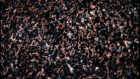 Oasis fan in muddle of crowd.