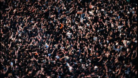 Oasis fan in muddle of crowd. 
