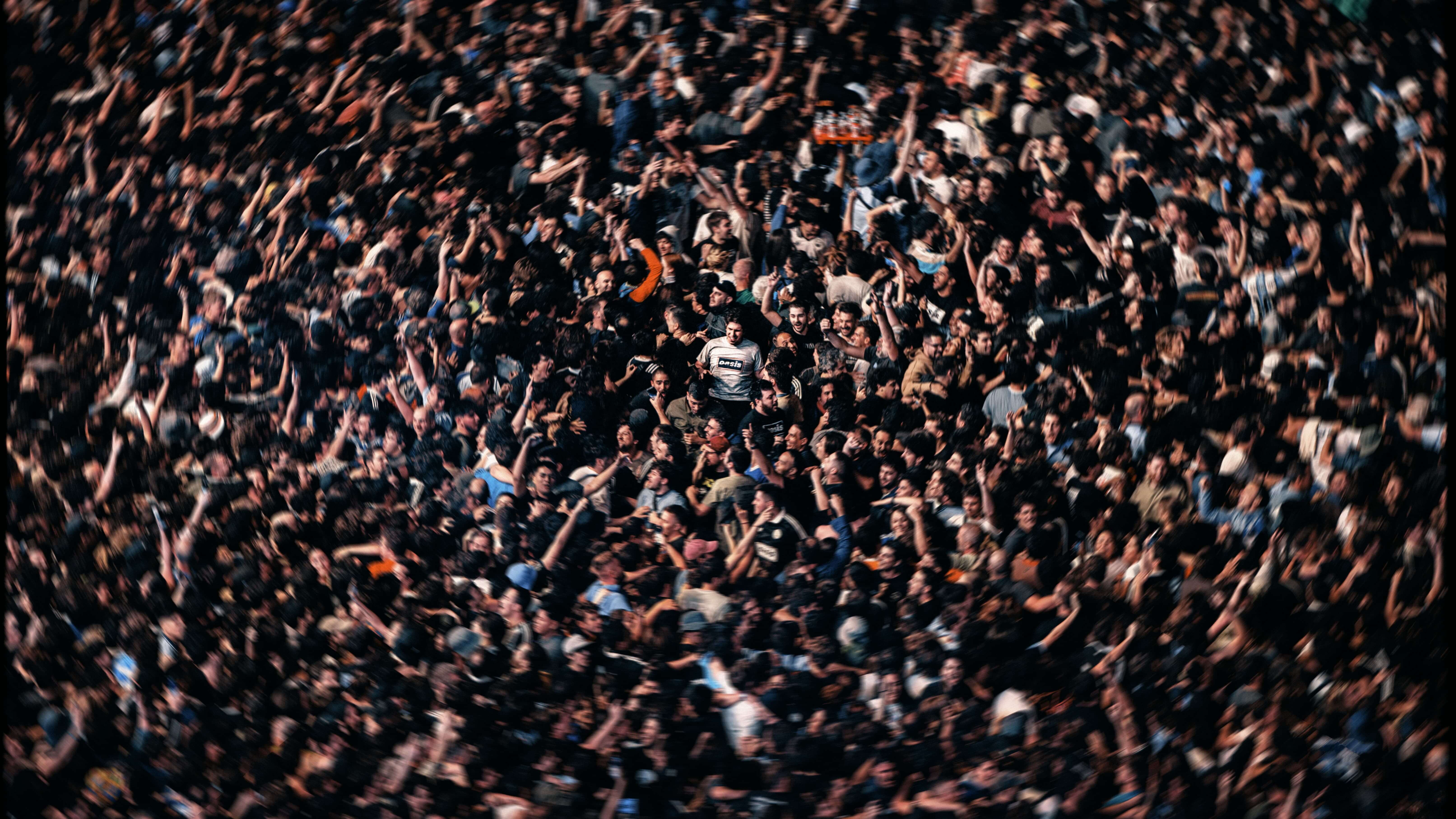 Oasis fan in muddle of crowd. 