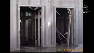 two elevator doors side by side with one showing buckling in the frame at right