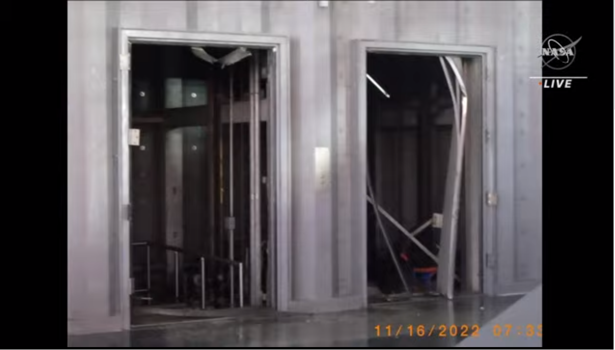 An image of the elevator doors at Launch Pad 39B blown in by the launch of Artemis 1.